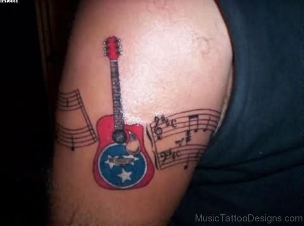 American native colored shoulder tattoo of guitar with notes