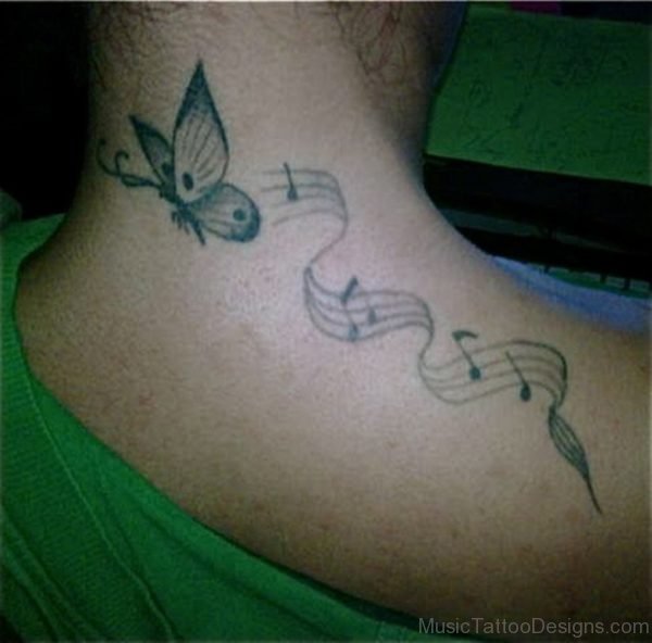 Black Butterfly Tattoo With Music Rhymes On Upper Back