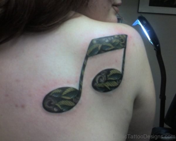 Green Leaves In Music Note Tattoo On Back 