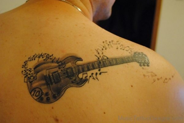 Grey Ink Guitar With Music Notes Tattoo On Back