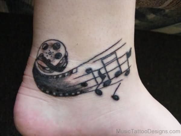 Grey Ink Music Tattoo On Ankle