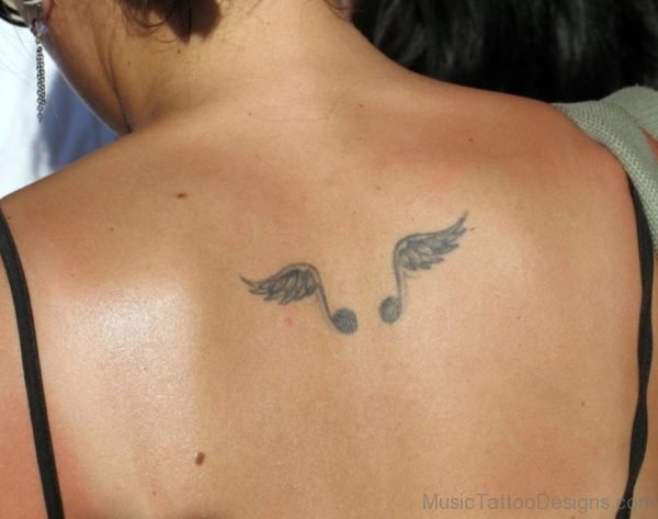 Music Notes And Wings Tattoo