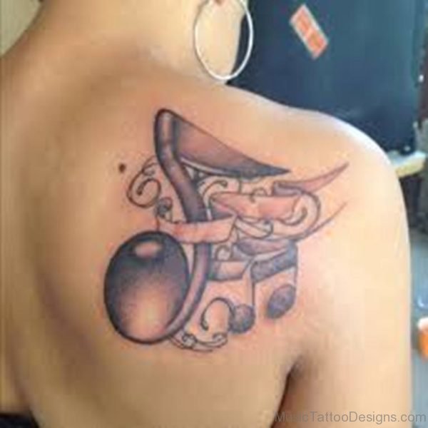 Music Notes And A Fold Banner Tattoo On Back Shoulder