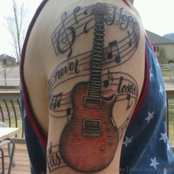 Music Notes And Letters Guitar Tattoo On Shoulder