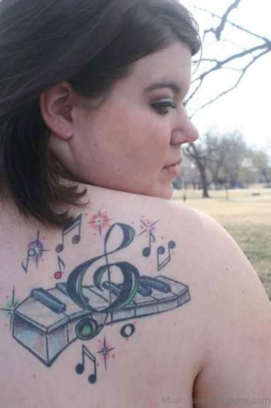 Music Notes With Piano Keys Tattoo On Back