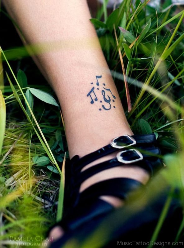 Music notes tattoo on a girls leg
