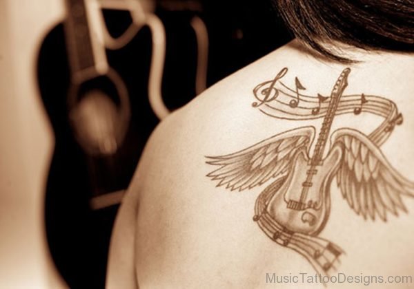 Winged Guitar Tattoo With Music Notes On Back