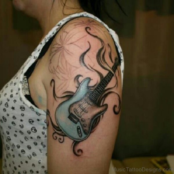 Woman With Amazing Guitar Tattoo On Shoulder