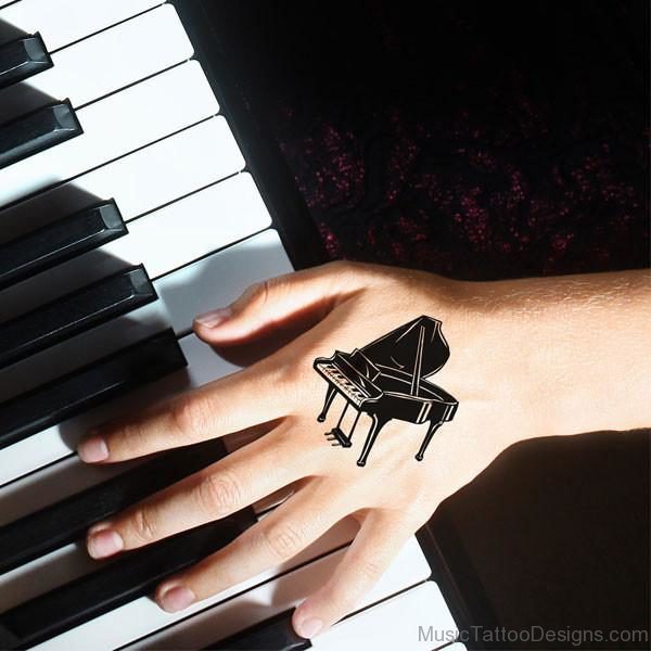 Black Ink Piano Tattoo On Hand