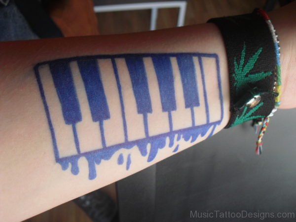 Blue Ink Piano Keys Tattoo On Forearm