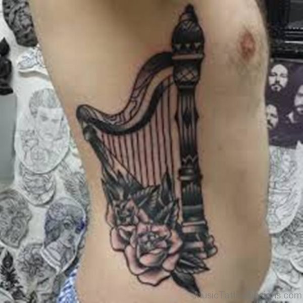 Flower And Harp Tattoo On Rib