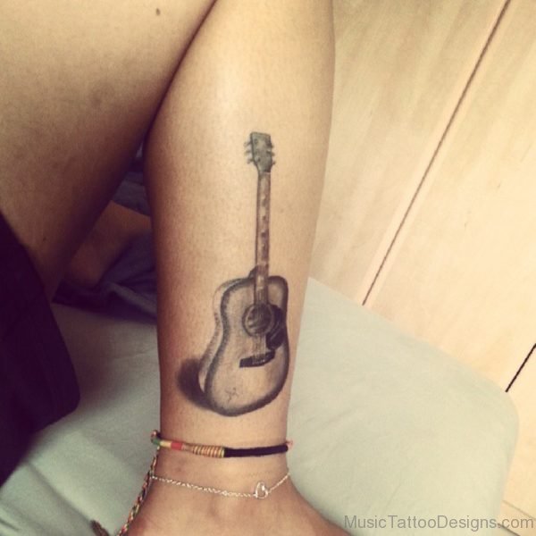 Girl With Grey Colored Guitar Tattoo On Leg
