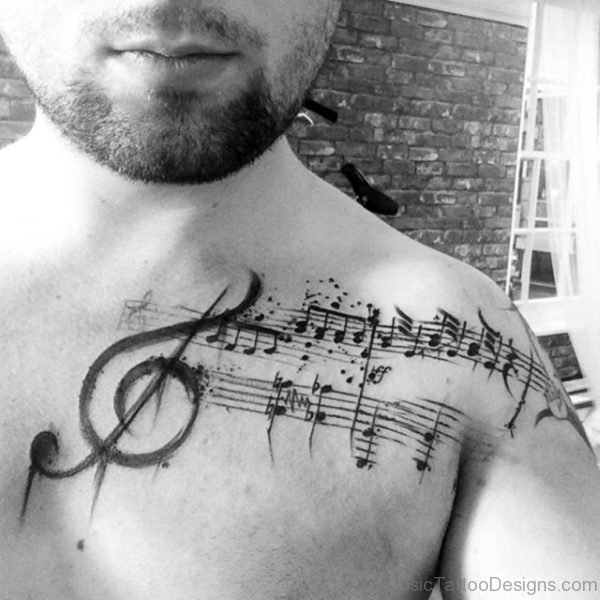 Guy With Musical Clef Tattoo On Shoulder