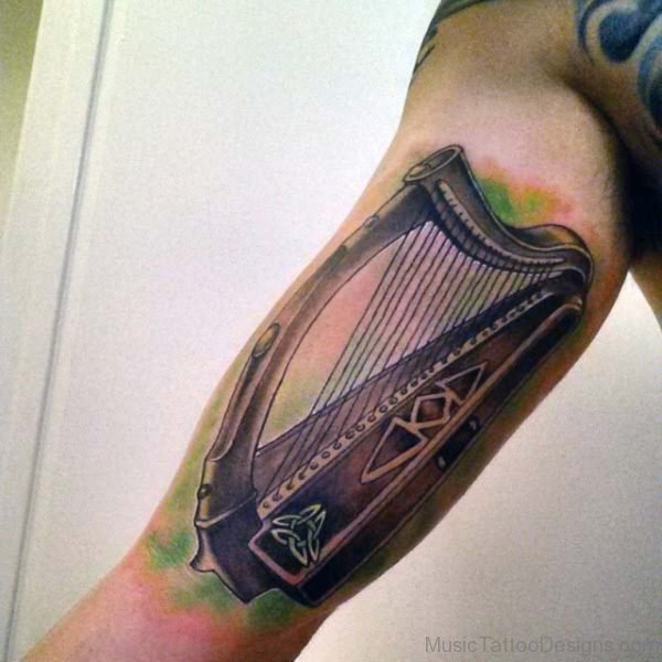 Impressive Harp Tattoo On Bicep