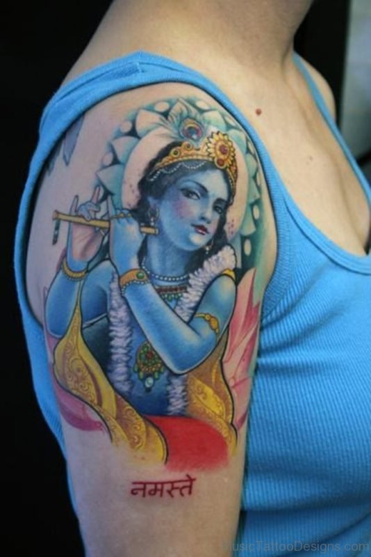 Lovely deity krishna with flute tattoo on shoulder