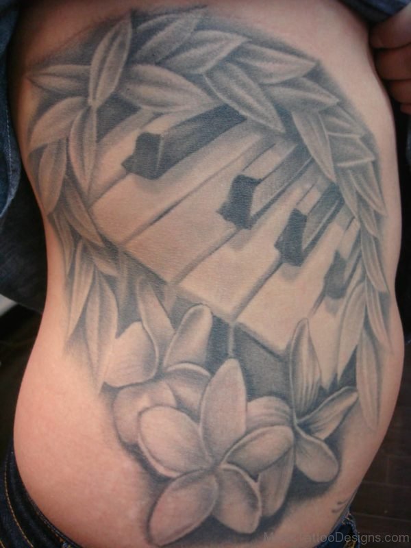 Realistic Leaves And Flowers With Piano Keys Tattoo On Side Rib