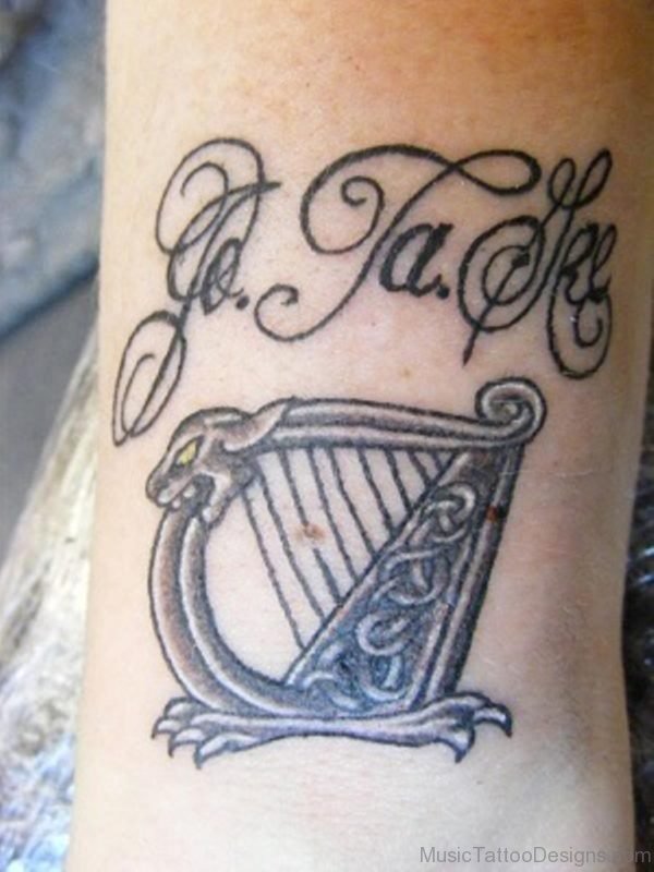 Wording And Harp Tattoo Design