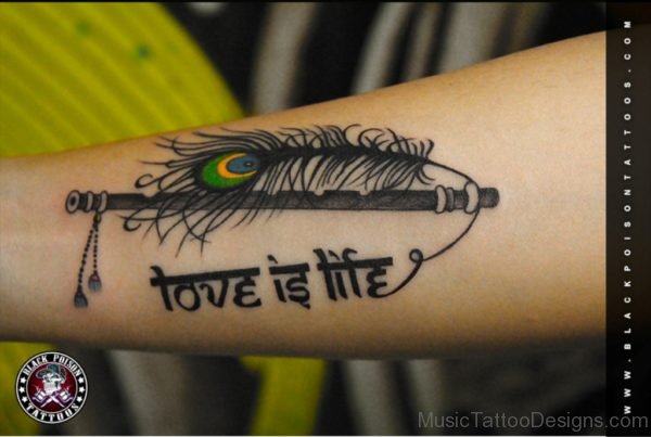 Peacock feather with flute tattoo On Arm