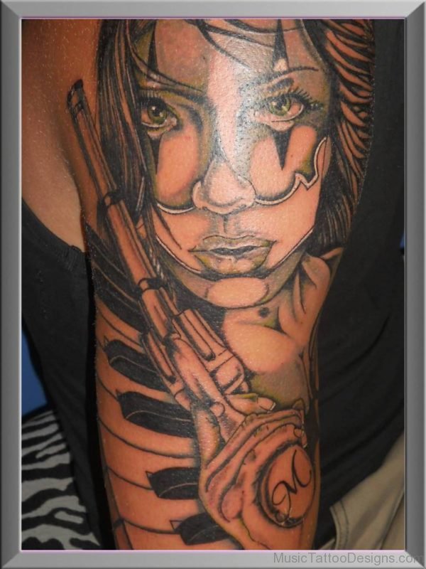 Latino Girl Face With Gun And Piano Keys Tattoo